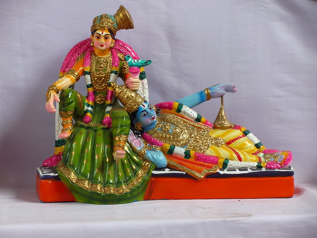 Lord Krishna with his head on the lap of the Alvar saint, Andal